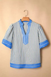 Blue and white striped V-neck shirt with decorative stitching and contrast trim