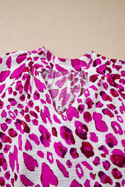 Vibrant leopard print V-neck blouse with gathered neckline detail.