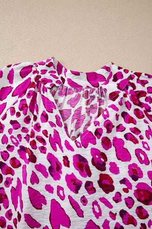 Vibrant leopard print V-neck blouse with gathered neckline detail.