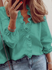 Teal blouse with cascading ruffle front and balloon sleeves.