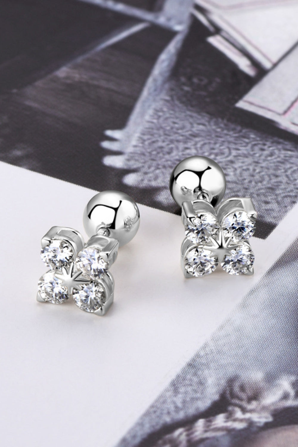 Silver stud earrings with four clear stones in a flower design, sterling silver.