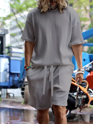 Men's grey ribbed two-piece set with drawstring shorts and short-sleeve t-shirt.