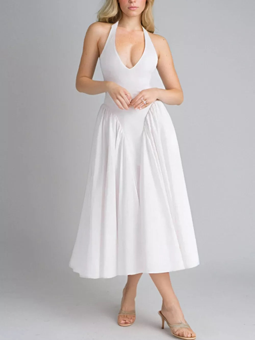 White halter neck midi dress with deep v-neck and full skirt.
