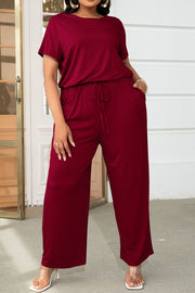 Wine relaxed fit jumpsuit with short sleeves, drawstring waist, and wide legs.