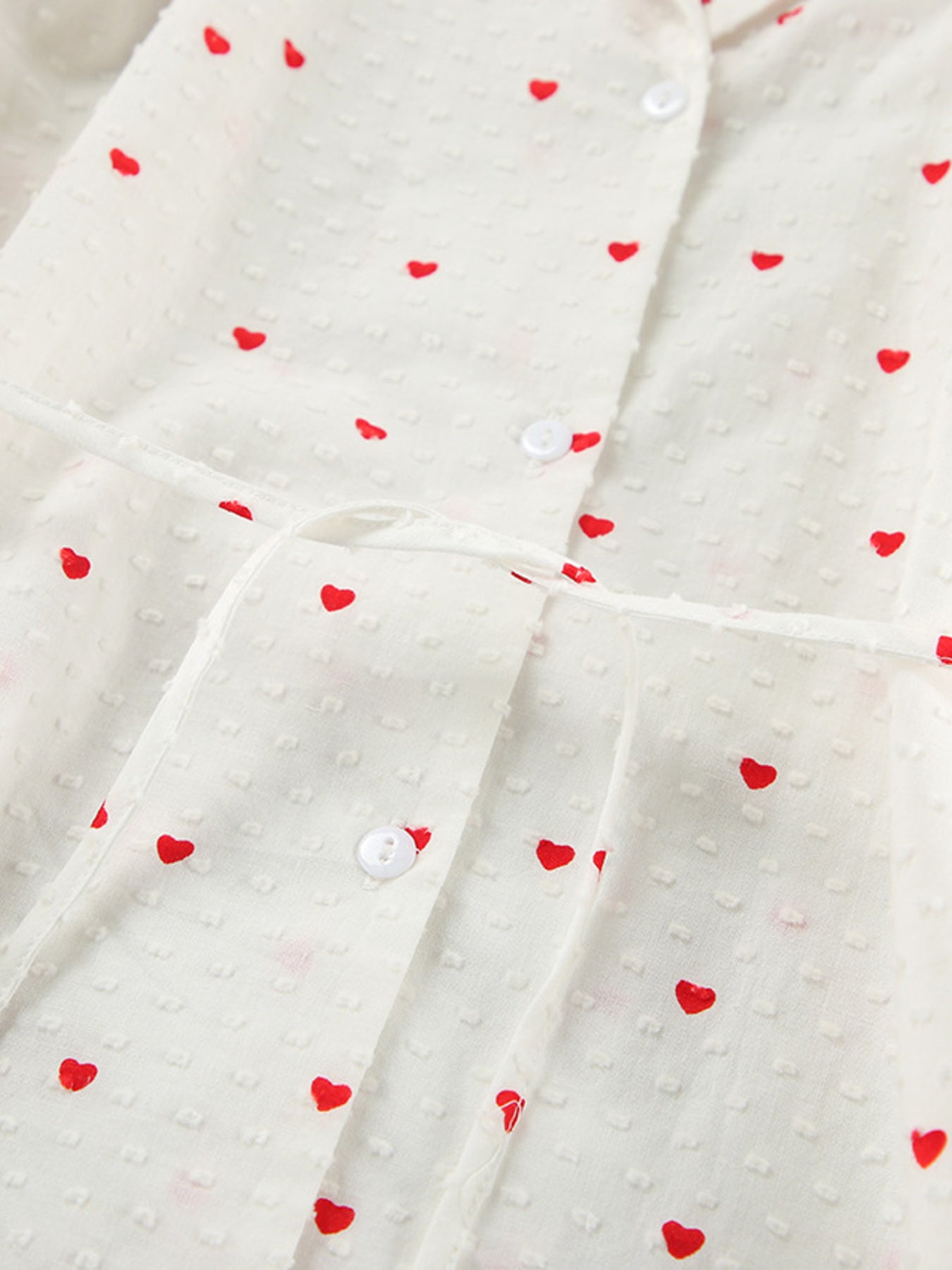 White cotton pajama set with red heart print, button-down front, and tie waist.