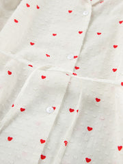 White cotton pajama set with red heart print, button-down front, and tie waist.