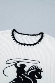 White ribbed sweater vest with black rodeo graphic and contrast trim neckline.