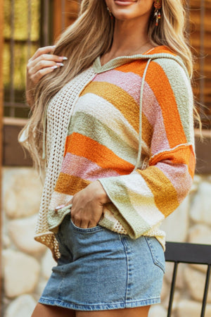 Colorblock knit hoodie with crochet side panels and drawstring hood.