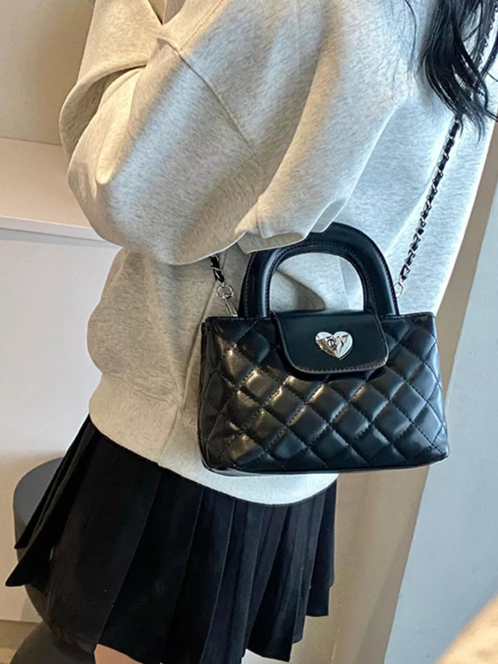 Quilted Heart Lock Crossbody Bag in Black, close-up detail