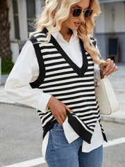 Black and white striped knit V-neck vest with side slits, worn over a white shirt.