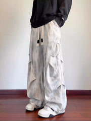 Vintage wash utility cargo pants in off-white with drawstring and multiple pockets.
