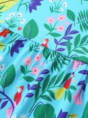 Blue cotton toddler dress with playful floral and bird print, gathered waist detail.
