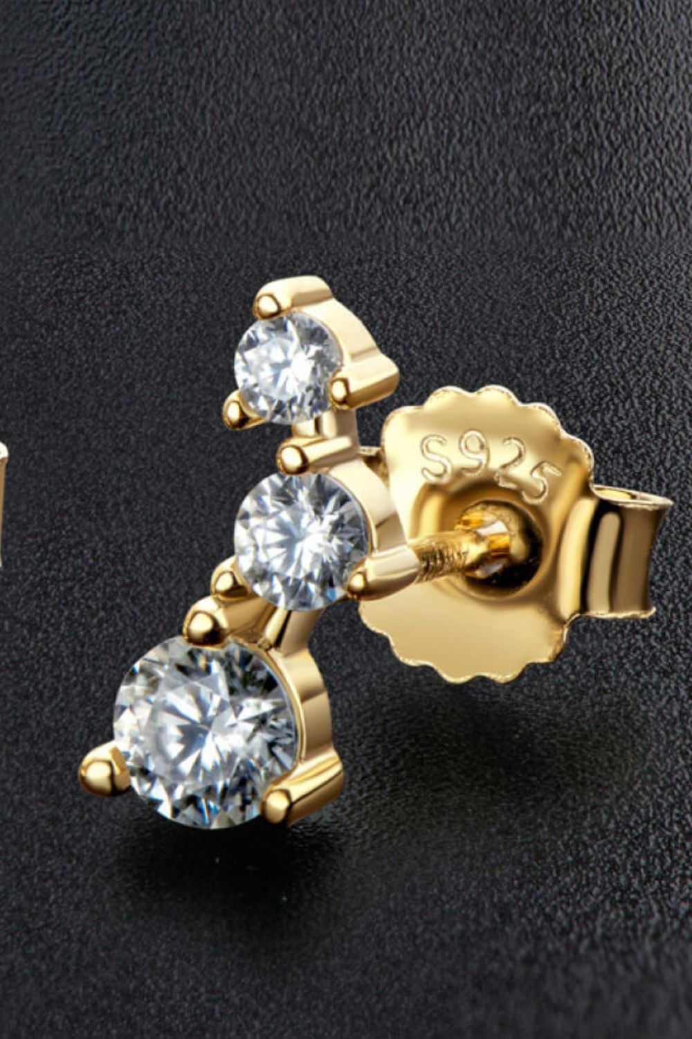 Gold moissanite cluster stud earrings with three round stones and S925 marking.