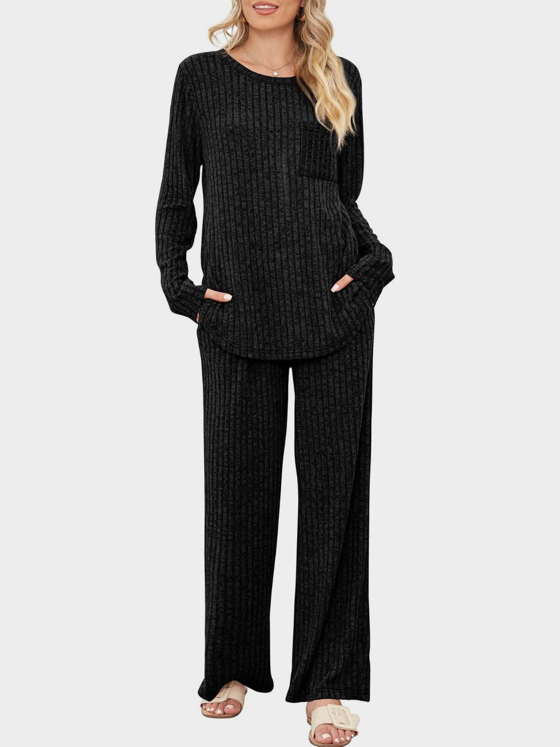Black ribbed knit lounge set with long sleeves, crew neck, chest pocket, and wide-leg pants.