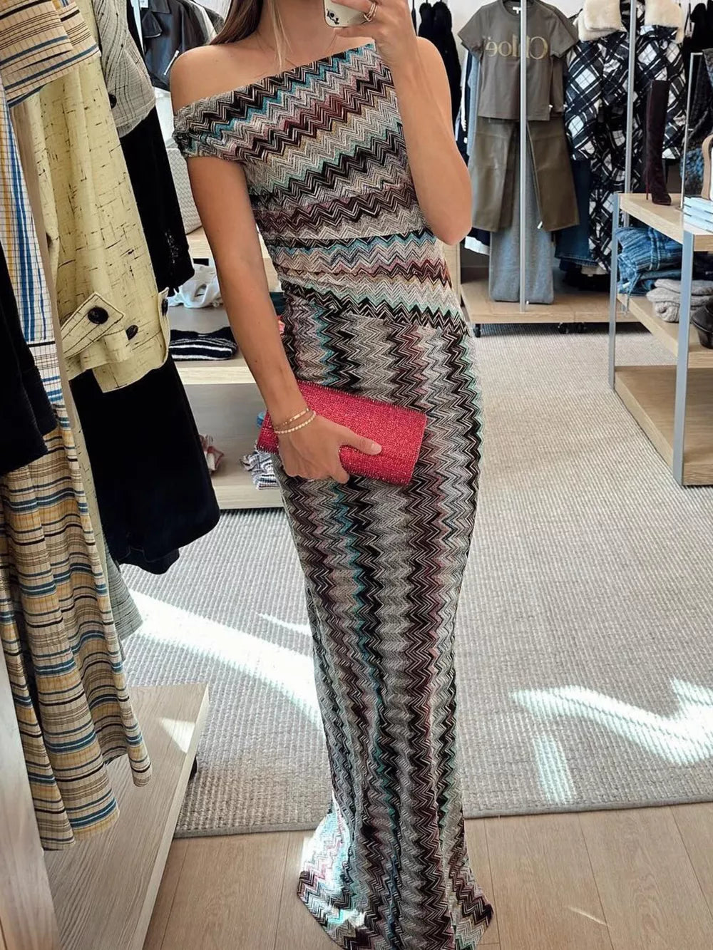 Vibrant one-shoulder maxi dress with chevron pattern and bodycon fit.
