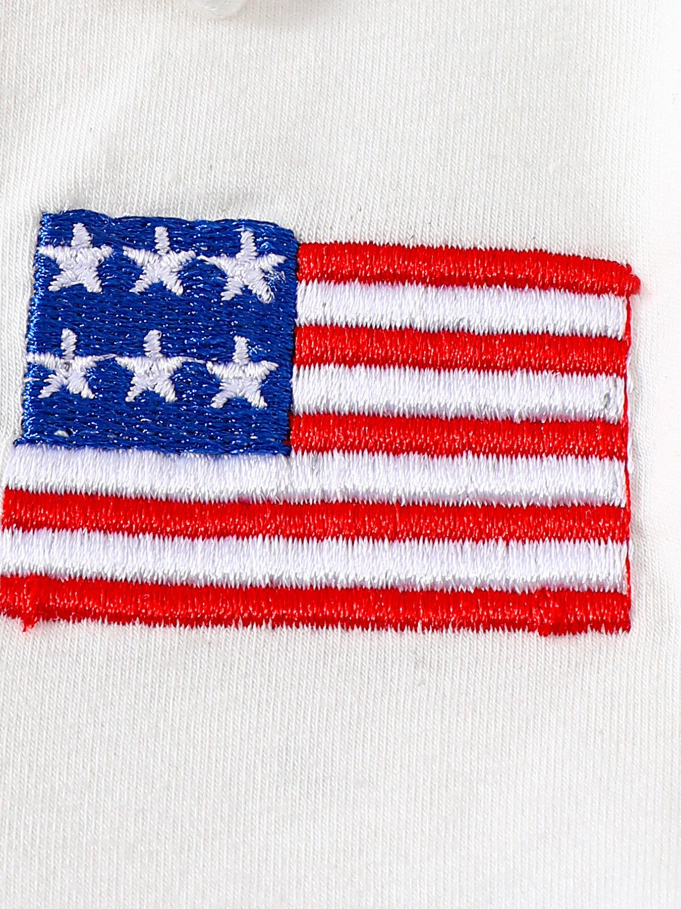 White cotton baby outfit with embroidered American flag detail