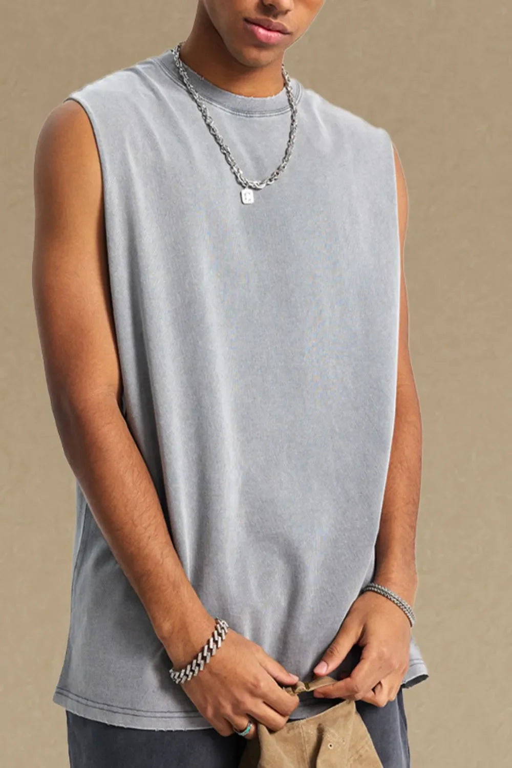 Gray washed cotton muscle tank with raw hem and crew neck.