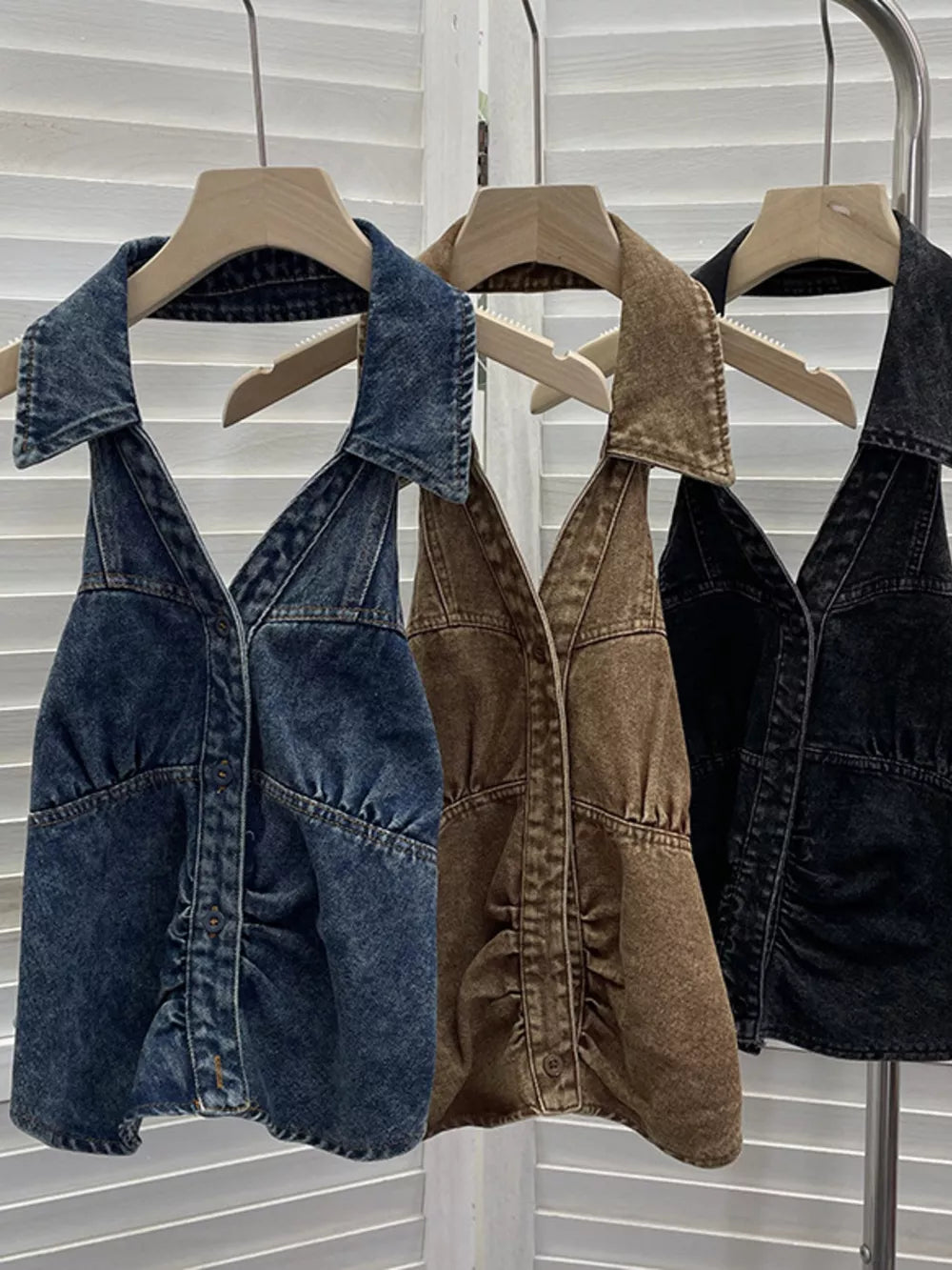 Gathered denim halter top with collar in blue, khaki, and black, featuring button front and V-neck.