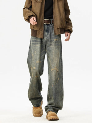 Distressed blue wide leg men's jeans with ripped details.