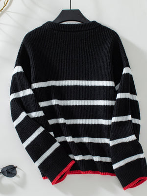Black ribbed knit sweater with white stripes and red trim