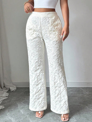 Textured white high-waist wide-leg maternity pants with pockets and a floral pattern.
