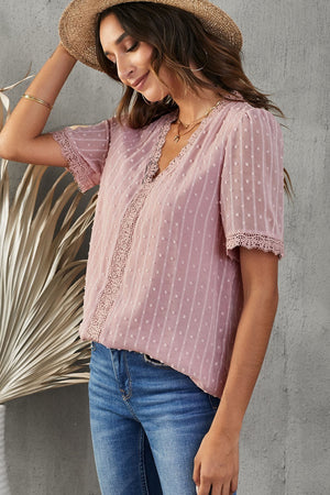 Dusty pink dotted swiss blouse with lace trim neckline and short sleeves.