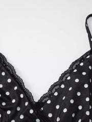 Black polka dot cami with white dots and black lace trim neckline.