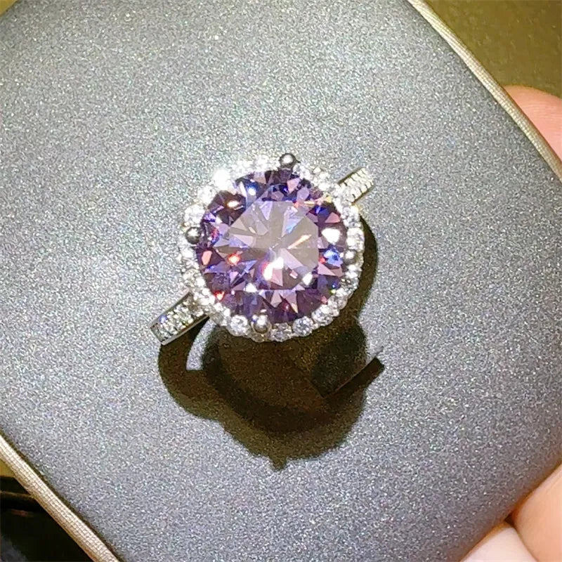Violet halo sterling silver ring with a large purple center stone and small clear accent stones.