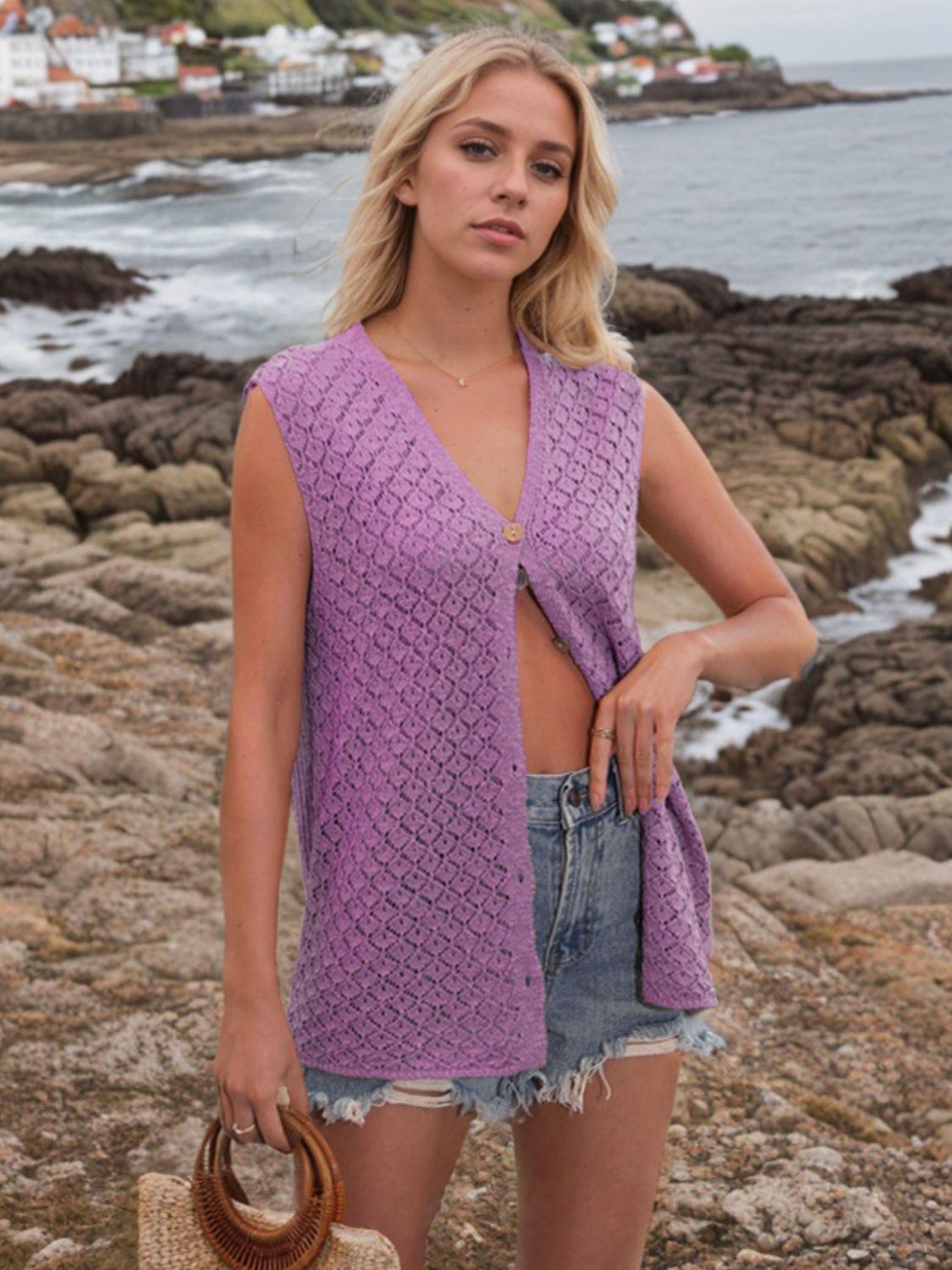 Lilac openwork button-down knit vest with a V-neck and short sleeves.