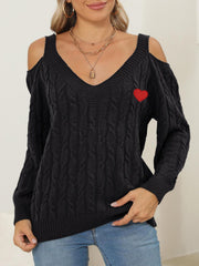 Black open shoulder cable knit sweater with red heart detail and v-neck.