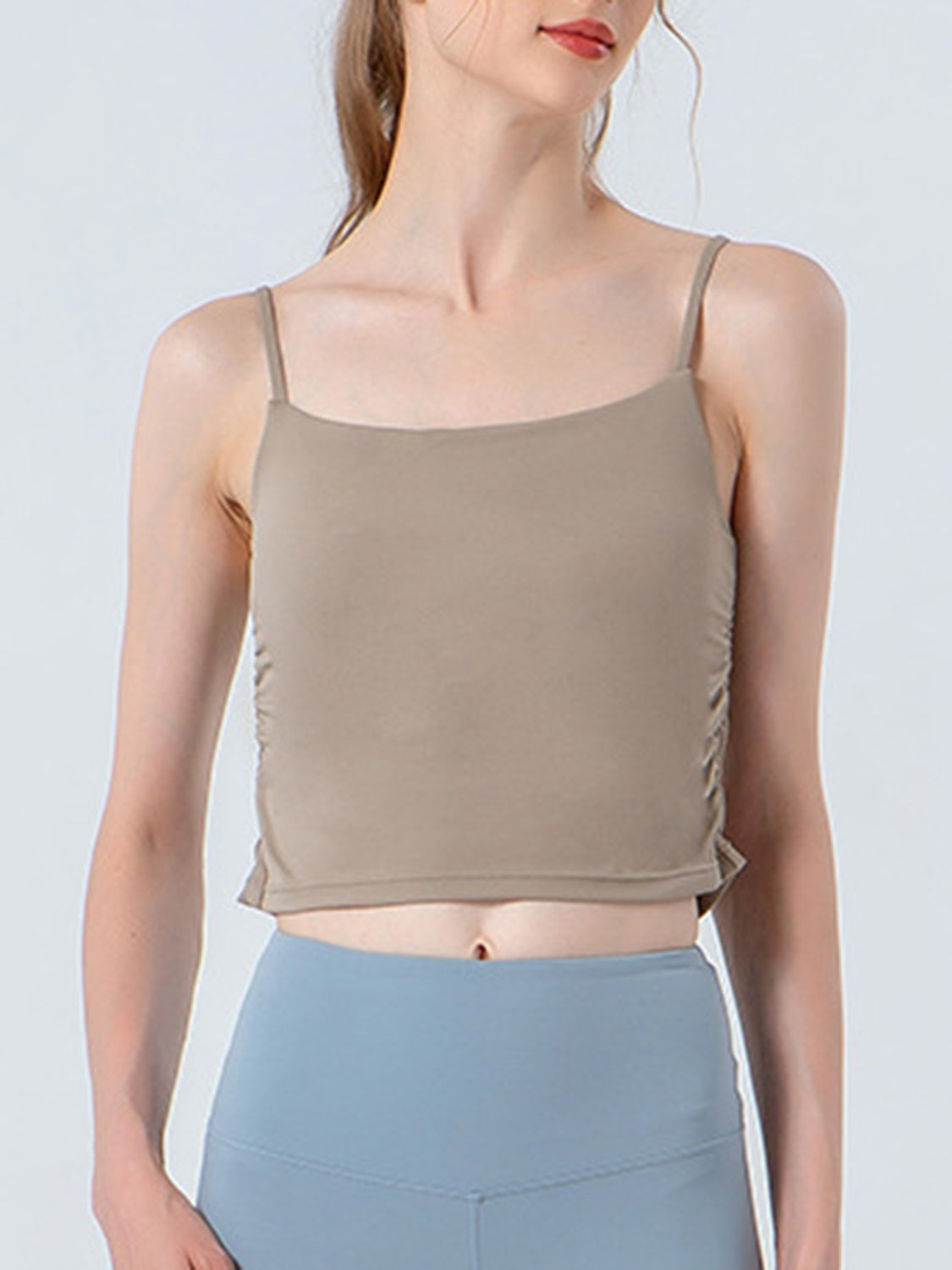 Beige ruched side tank top with spaghetti straps and a square neckline.