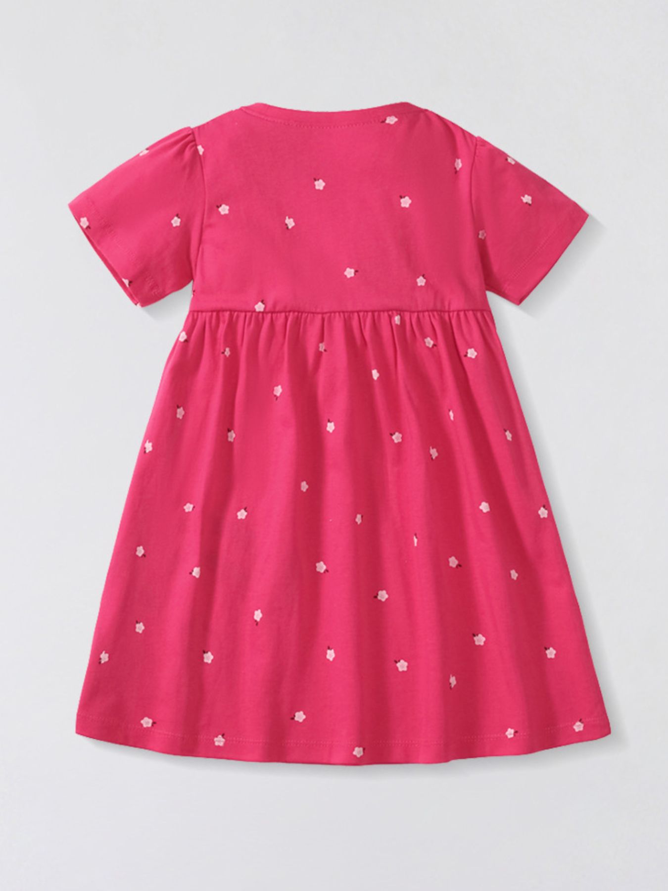Toddler aline dress in pink cotton with a scattered floral print and short sleeves.