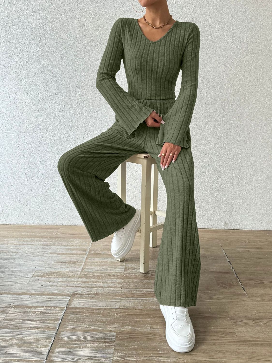Moss green ribbed knit loungewear set with flared sleeves and pants.