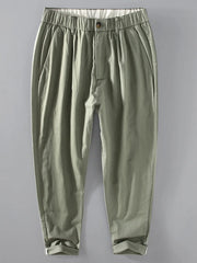 Men's relaxed fit cropped sweatpants in sage with elastic waistband and cuffed hems.