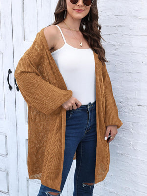 Caramel cable knit cocoon cardigan with open front and long sleeves.