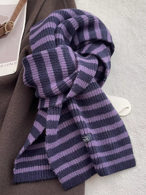 Cozy wool striped winter scarf in lavender and navy with a subtle brand tag detail.