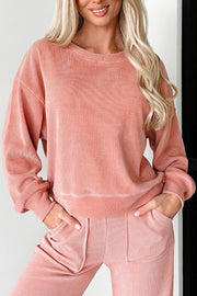 Pink corduroy loungewear set with crewneck sweatshirt and relaxed fit pants.