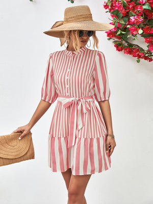 Blush pink and white vertical stripe shirred waist dress with tie belt and tiered skirt.