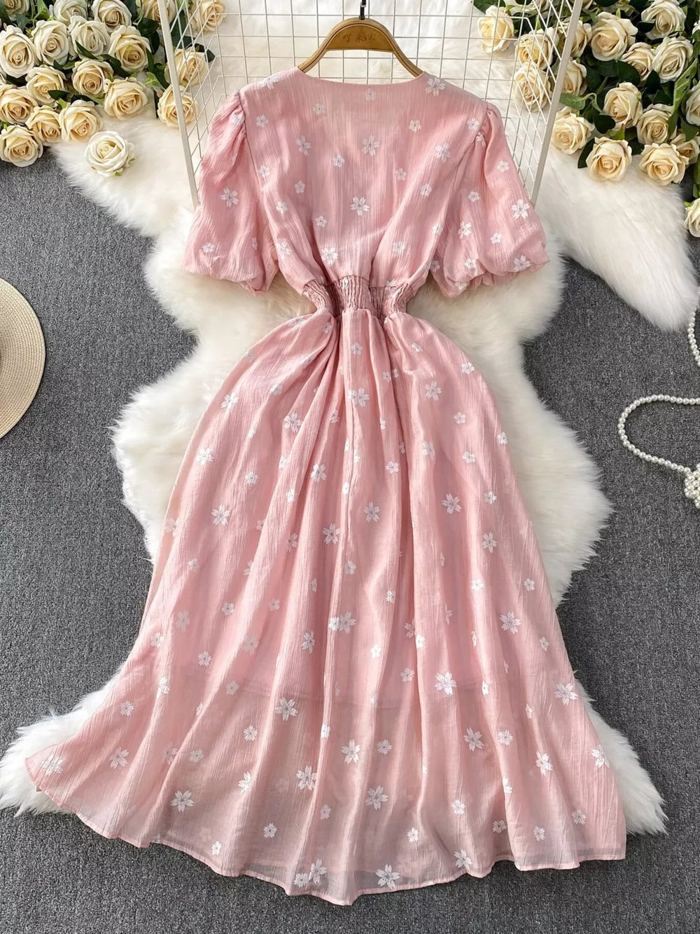 Dusty pink embroidered puff sleeve midi dress with elastic waist and floral pattern.