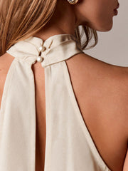 Beige halter camisole with pearl button closure and open back detail