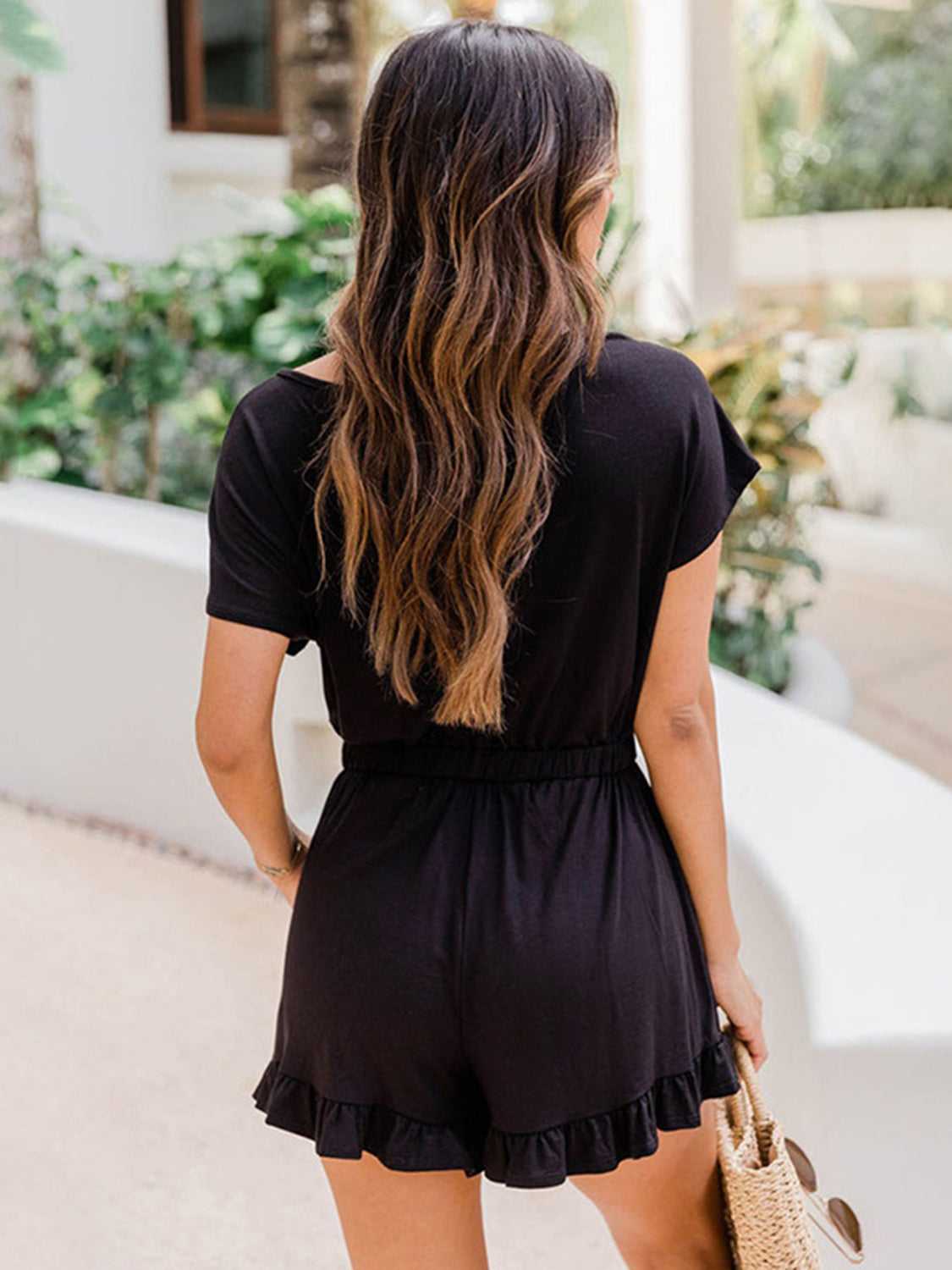 Black off-shoulder romper with ruffle hem and elastic waist