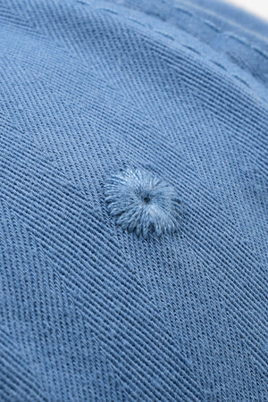 Cobalt blue denim baseball cap with raw edge detail and embroidered eyelet.