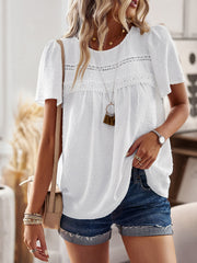 White textured puff sleeve blouse with lace yoke detail and short sleeves.