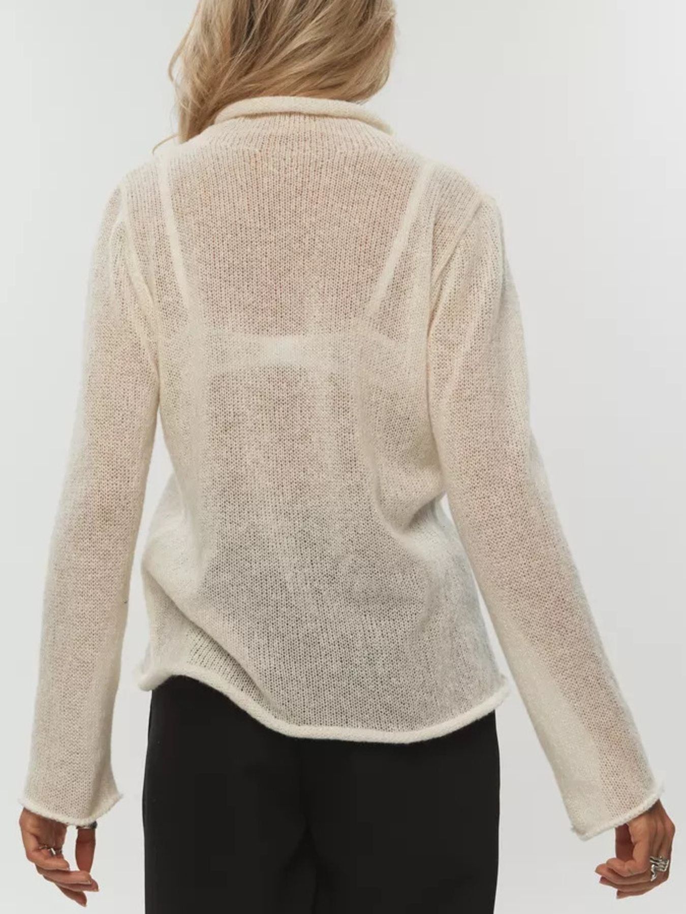 Sheer mock neck knit sweater in apricot with a relaxed fit and long sleeves.