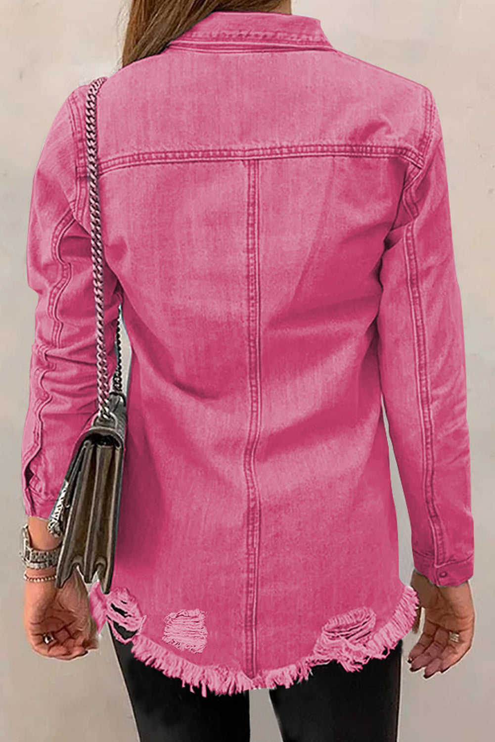 Pink distressed denim shirt jacket with raw edges and frayed hem.