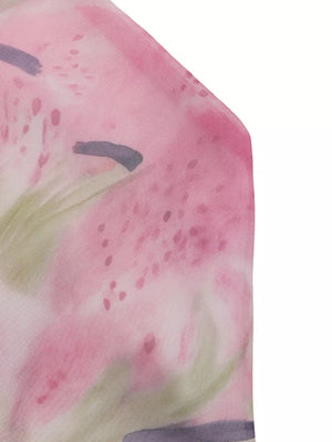 Vibrant floral halter cami with pink and green watercolor print and ruffle hem detail.
