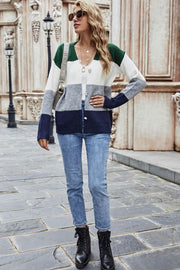 Colorblock acrylic cardigan with metallic trim in green, white, grey, and navy blue.