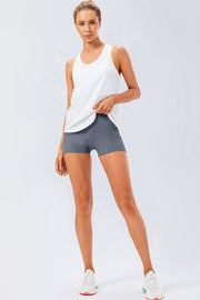 Sculpted performance shorts in gray with side pockets, paired with a white tank top.