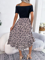 Floral off-shoulder midi dress in black with a light floral print skirt and ruffled hem.