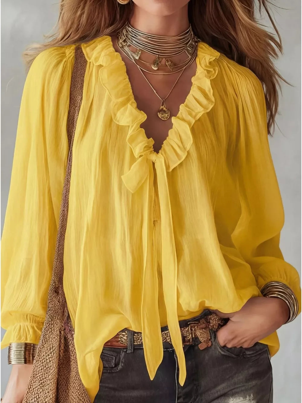 Yellow frilled tie-front shirt with ruffled neckline and long sleeves.